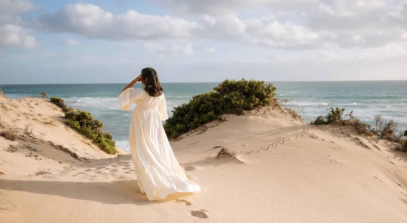 Pregnancy session in Rye with golden sand dunes and open sea